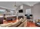 The main bedroom has vaulted ceiling, hardwood floors, a bed, dresser, TV, and office area with 3 large windows at 1510 Central Ave, Indianapolis, IN 46202