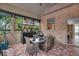 Bright sunroom featuring a brick accent wall, large windows, and glass-top table with chairs at 1510 Central Ave, Indianapolis, IN 46202