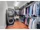 Organized walk-in closet with washer and dryer, storage racks, and space for clothes and accessories at 1510 Central Ave, Indianapolis, IN 46202