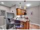 Basement wet bar with a sink, refrigerator, wooden cabinets, and granite countertops at 1510 Central Ave, Indianapolis, IN 46202