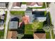 Aerial view of a cozy home featuring a detached garage, well-manicured lawn, and inviting outdoor space at 1615 N E St, Elwood, IN 46036