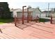 Wooden back deck with wooden railing, overlooking a detached garage and other houses in the neighborhood at 1615 N E St, Elwood, IN 46036