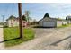 Large detached garage with a driveway, plus a charming deck leading to the main house at 1615 N E St, Elwood, IN 46036