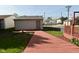 Backyard showing the deck, landscaping, and walkway leading to the detached garage at 1615 N E St, Elwood, IN 46036