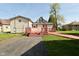 Charming exterior featuring a large deck connecting to a well-maintained lawn and detached garage at 1615 N E St, Elwood, IN 46036
