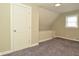 Bedroom featuring neutral walls and carpet, textured ceiling, and a single door to the side at 1615 N E St, Elwood, IN 46036