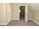 Bedroom featuring neutral walls and carpet, textured ceiling, and two doorways at 1615 N E St, Elwood, IN 46036