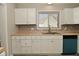 Well-lit kitchen featuring white cabinetry, butcher block countertops, mosaic backsplash, and modern stainless steel appliances at 1615 N E St, Elwood, IN 46036