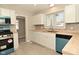 Updated kitchen boasts white cabinets, mosaic backsplash, butcher block counters, and modern appliances at 1615 N E St, Elwood, IN 46036