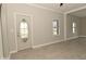 Freshly painted living room with new flooring and an oval glass front door; a bright and inviting space at 1615 N E St, Elwood, IN 46036