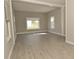 Bright living room showcasing neutral paint, new flooring, and multiple windows for ample natural light at 1615 N E St, Elwood, IN 46036