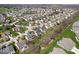 An aerial view of a neighborhood with manicured lawns and a large pond at 16726 Blackbird Ct, Noblesville, IN 46060