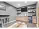 Basement bar featuring a beverage cooler, bar shelves, television and barstool seating at 16726 Blackbird Ct, Noblesville, IN 46060
