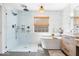 Bright bathroom showcases a soaking tub, glass-enclosed shower, and stylish vanity at 16726 Blackbird Ct, Noblesville, IN 46060