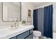 Charming bathroom with navy blue vanity, modern sink, and stylish shower curtain at 16726 Blackbird Ct, Noblesville, IN 46060