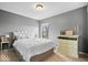 Serene bedroom with white bedding, soft natural light, and stylish decor on a dresser at 16726 Blackbird Ct, Noblesville, IN 46060