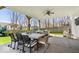 Inviting covered patio with an outdoor dining table and comfortable seating area at 16726 Blackbird Ct, Noblesville, IN 46060