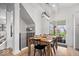 Sunlit dining area with a modern light fixture, wood table with seating for six, and access to the outdoors at 16726 Blackbird Ct, Noblesville, IN 46060