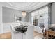 Sophisticated dining room with a gray color scheme, ornate chandelier, and views of the outdoors at 16726 Blackbird Ct, Noblesville, IN 46060