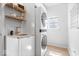 Well-lit laundry room with a stacked washer/dryer and stylish decor at 16726 Blackbird Ct, Noblesville, IN 46060