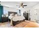 Spacious main bedroom features a dark wood bed frame, matching dresser, and two windows at 16726 Blackbird Ct, Noblesville, IN 46060