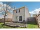 View of the back of the home with a sliding door, small patio and garden area at 16780 Lowell Dr, Noblesville, IN 46060