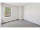 Bedroom featuring new carpet and a large window letting in natural light at 16780 Lowell Dr, Noblesville, IN 46060