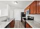 Modern kitchen featuring wood cabinets, marble countertops, and stainless steel appliances at 16780 Lowell Dr, Noblesville, IN 46060