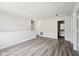 Spacious living room with hardwood floors, natural light, and access to bathroom at 16780 Lowell Dr, Noblesville, IN 46060
