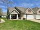 Charming townhome featuring a well-manicured lawn, attached garage, and inviting front porch perfect for relaxing at 16869 Cimarron Pass, Noblesville, IN 46060