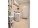 Functional laundry room with appliances, storage shelves, and convenient access to the backyard at 16869 Cimarron Pass, Noblesville, IN 46060