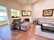 Cozy living room featuring hardwood floors, comfortable seating, a fireplace, and natural light at 16869 Cimarron Pass, Noblesville, IN 46060