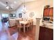 Open-concept living and dining area with hardwood floors, a vaulted ceiling, and contemporary lighting at 16869 Cimarron Pass, Noblesville, IN 46060