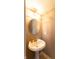 Charming half bathroom featuring a pedestal sink and round mirror at 1884 Misty Lake Dr, Indianapolis, IN 46260