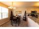 Cozy eat-in kitchen with a table and chairs and light-colored cabinets, open to dining area at 1884 Misty Lake Dr, Indianapolis, IN 46260