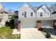 Charming home with an attached two car garage, gray siding, brick accents, and well-maintained landscaping at 1884 Misty Lake Dr, Indianapolis, IN 46260