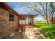 Backyard featuring a brick home and an attached sunroom at 1908 Roundhill Dr, Anderson, IN 46013