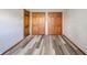 Bedroom featuring hardwood floors, neutral walls, and three closets for ample storage space at 1908 Roundhill Dr, Anderson, IN 46013