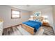Cozy bedroom featuring a wooden bed frame, bright blue accents, and carpet at 1908 Roundhill Dr, Anderson, IN 46013
