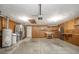Spacious garage featuring water heater, furnace, and access to inside the home at 1908 Roundhill Dr, Anderson, IN 46013