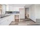 Well-lit kitchen boasts modern white cabinets and marble countertops with stylish backsplash at 1908 Roundhill Dr, Anderson, IN 46013