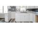 Updated kitchen features white cabinets, marble countertops, and stainless steel sink fixtures at 1908 Roundhill Dr, Anderson, IN 46013