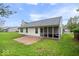 Expansive backyard with lush green grass, a charming patio, and a screened-in porch at 19516 Golden Meadow Way, Noblesville, IN 46060