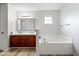 Spacious bathroom featuring double sinks, a soaking tub, and wood-look floors for a modern touch at 19516 Golden Meadow Way, Noblesville, IN 46060
