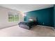 Bright bedroom with a large window offering pleasant views and a contrasting accent wall at 19516 Golden Meadow Way, Noblesville, IN 46060