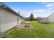 View of the backyard with ample lawn space, a concrete patio, and exterior storage shed at 2102 Coldwater Cir, Indianapolis, IN 46239