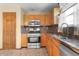 A kitchen features stainless steel appliances, tile backsplash and light wood cabinets at 2102 Coldwater Cir, Indianapolis, IN 46239