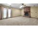A bright living room features a fireplace, carpet flooring and many windows for natural light at 2102 Coldwater Cir, Indianapolis, IN 46239