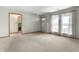 A living room features three windows, carpet floors and light colored walls at 2102 Coldwater Cir, Indianapolis, IN 46239