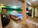 A finished basement bedroom featuring a queen bed, laminate flooring, and open closet at 2143 N Graham Ave, Indianapolis, IN 46218